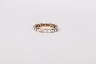 a close up of a diamond ring on a white surface