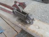 a clamp that is sitting on top of a piece of wood