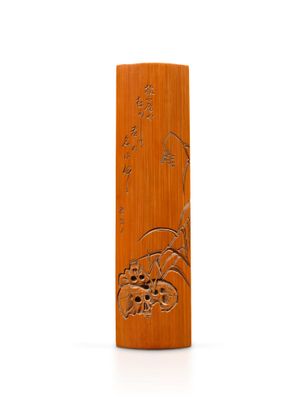 a wooden vase with a design on it on a white surface