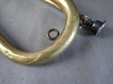 a metal hook with a ring on it on a table