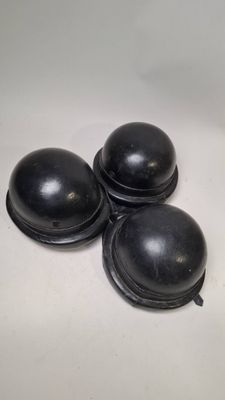 three black knobs sitting on top of a white surface