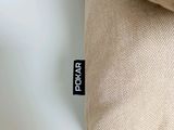 a close up of a pillow on a white surface
