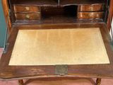 a small wooden desk with a drawer on top of it
