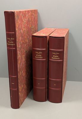 two red books sitting next to each other on top of a table