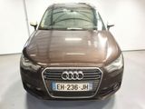 the front of a brown audi car parked in a garage