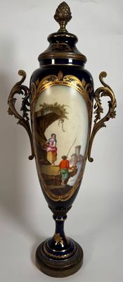 a vase with a painting on it sitting on a table
