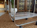 a clear plastic cart sitting on the carpet in the living room