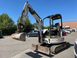 a small excavator that is sitting in a parking lot