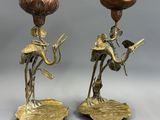 pair of antique brass candlesticks with figurines of a man and woman