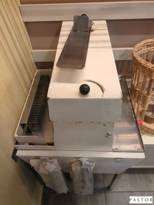 a machine that is sitting on a table next to a basket