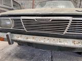 a rusted old truck parked in a garage