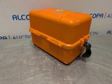 a close up of an orange plastic box on a metal surface