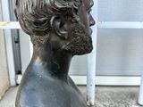 statue of a man ' s head with a beard and a moustache