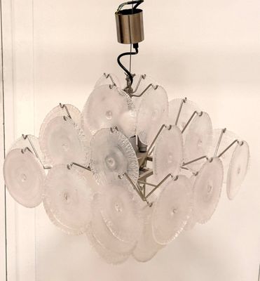 a glass chandelier hanging from the ceiling in a room