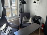 a living room with two chairs and a table in it