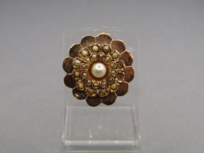 a close up of a gold ring with pearls on it