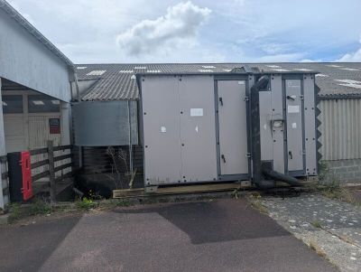 two portable toilets on the side of a building