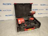 a tool box with two tools in it sitting on a floor