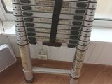 a stack of ladders sitting on the floor by a window