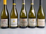several bottles of wine are lined up in a row on a table