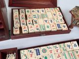 a wooden box with a set of mahjong tiles in it