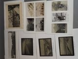 a wall of old photographs on the wall of a room