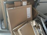 a pile of boxes and other items in a garage