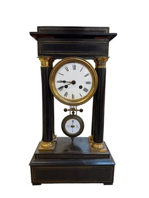 a black and gold clock sitting on top of a table
