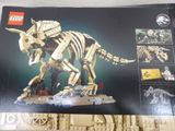 a box of legos with a picture of a t - rex on it