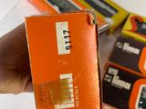 a person holding an orange box with a tape on it