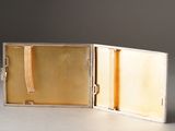a small silver box with a gold ribbon in it