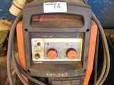 an orange and black welding machine sitting on top of a table