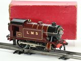 a toy train on the tracks with a box in the background
