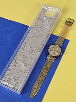 a watch that is sitting next to a box on a table