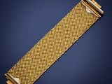 a gold bracelet with a clasp on a blue background
