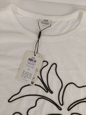 a white t - shirt with a black flower on it