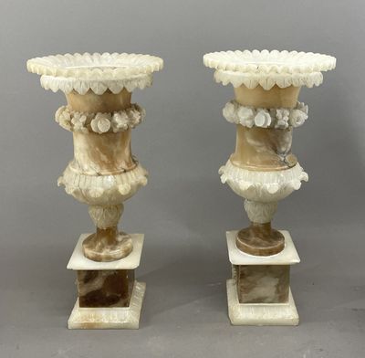 paire de vases en marbre sculpté sur socles, sur fond gris