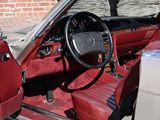 a red car with red leather seats and a black steering wheel