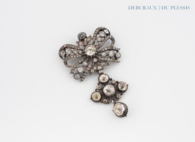 an antique diamond flower broochle and a pair of earrings