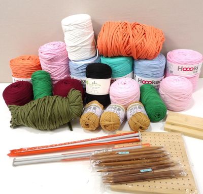 yarn, crochets, knitting needles, and knitting needles on a table