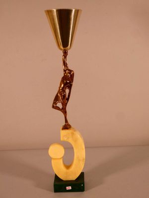 a sculpture of a man holding a cup on top of a table