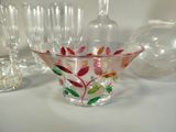 a glass vase that has been decorated with colorful leaves
