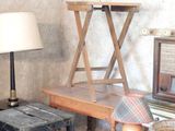 a living room with a television, table, and stools