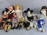 a lot of dolls that are sitting together on a table