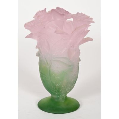pink and green glass vase with flowers in it on a white background