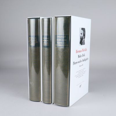 three books are stacked on top of each other in front of a white box