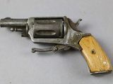 a small revolver with a wooden handle on a table