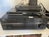 a lot of electronics sitting on top of a shelf