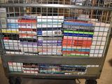 a metal cart with many books on it in a store