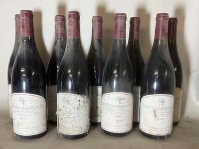 six bottles of red wine are lined up on a shelf